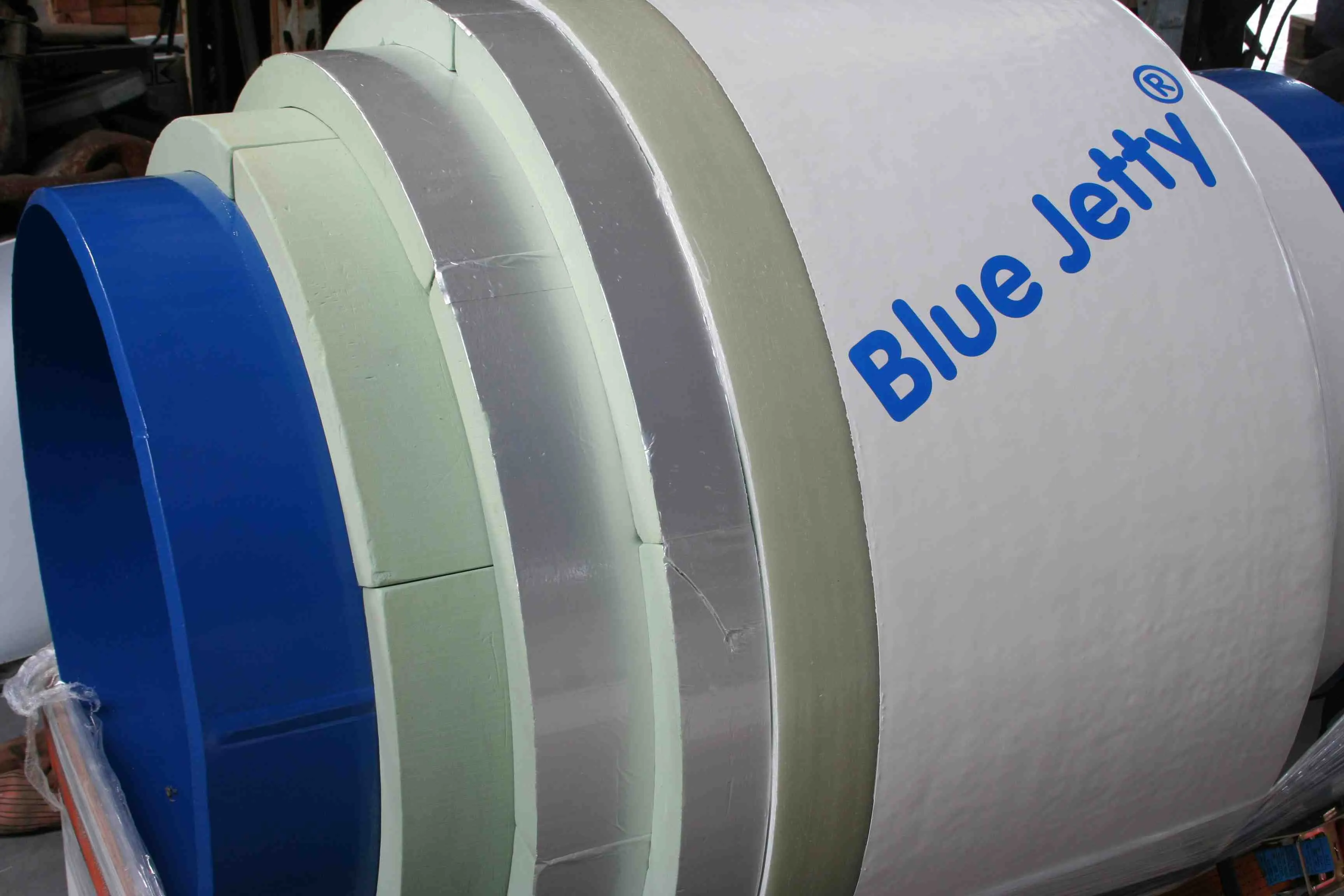 End of an insulated pipe showing the insulation layers and the Blue Jetty laminate