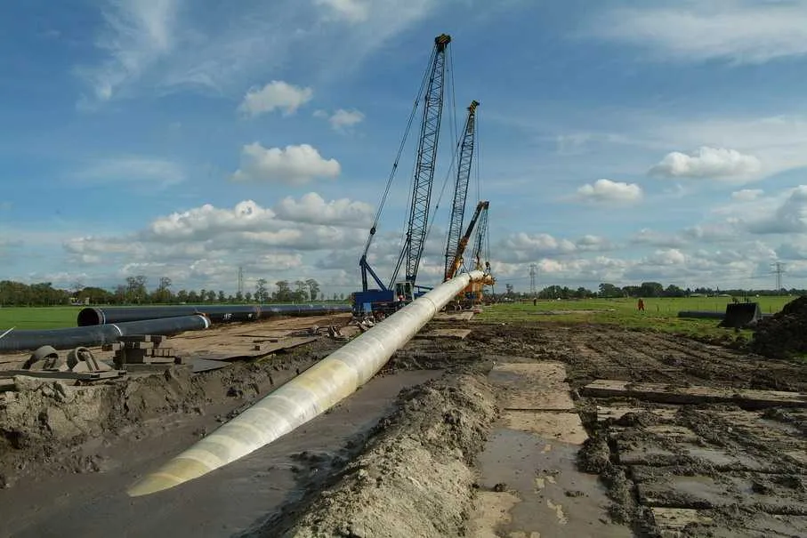 Coated pipe entering the ground during an HDD pull-back