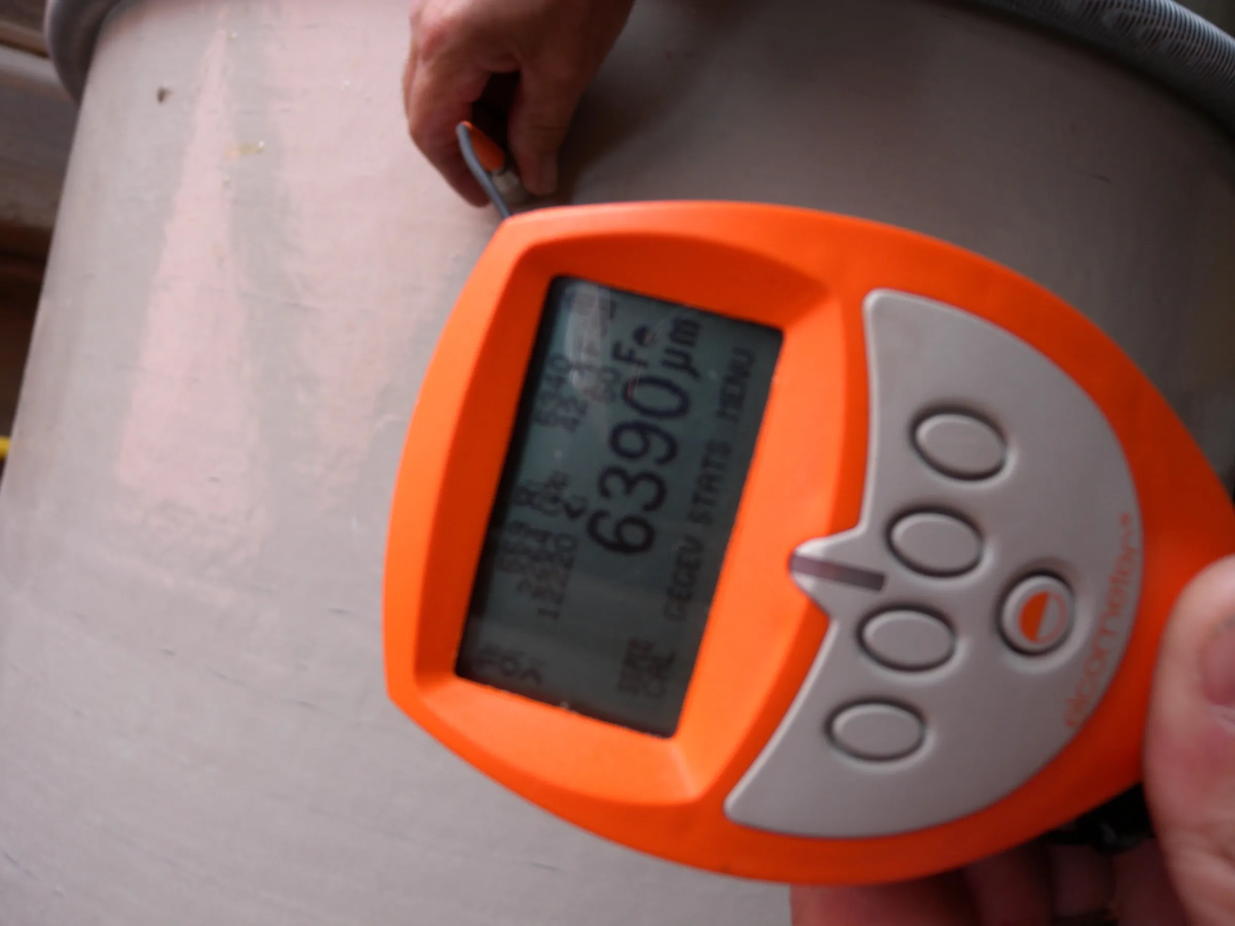 Coating thickness being checked with a handheld gauge